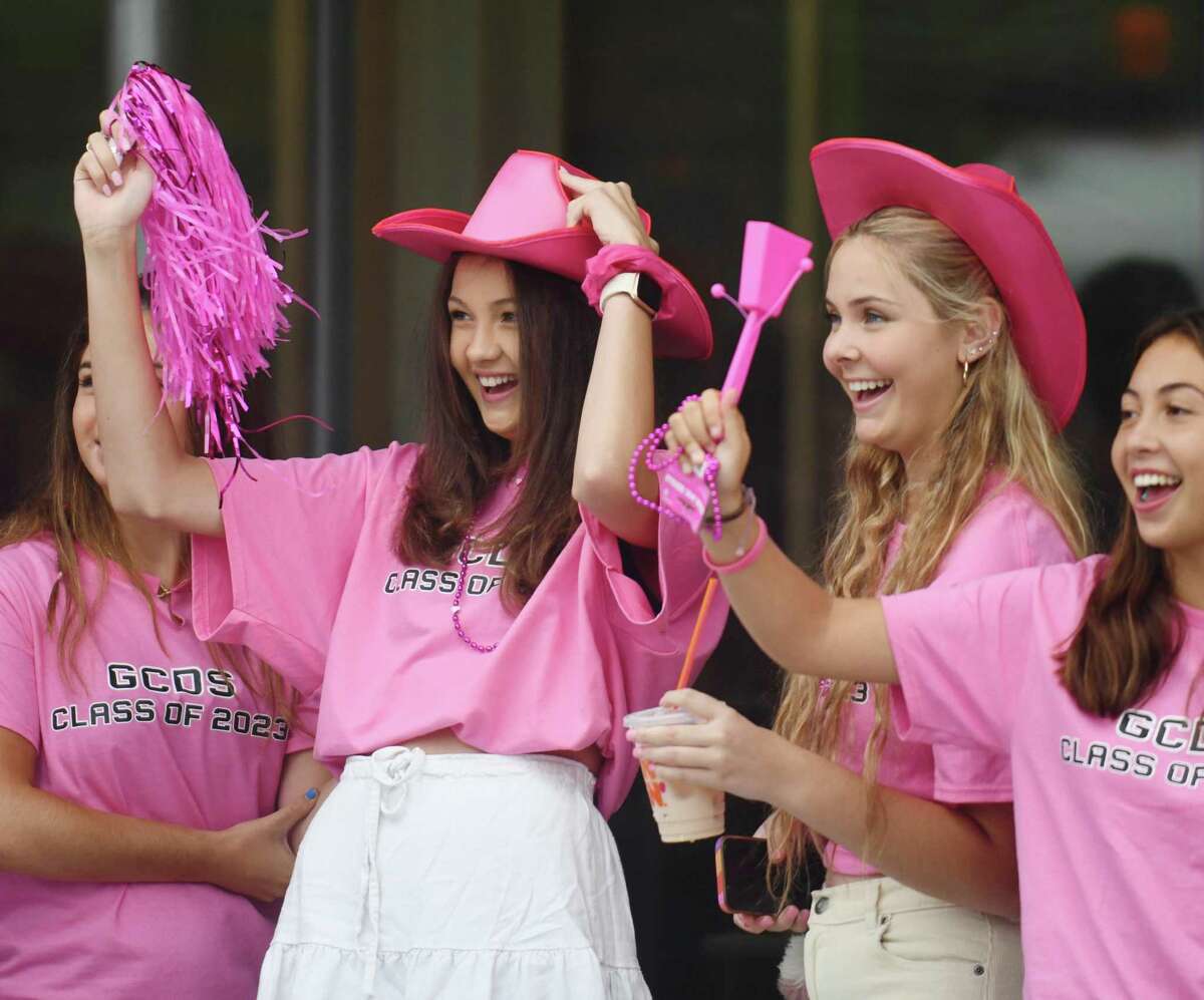 Seniors Kaylee Dunleavy, left, and Kim Konigsberg wear pink cowboy hats to welcome students on the first day of the 2022-2023 school year at Greenwich Country Day School's Upper School campus in Greenwich, Conn. Wednesday, Sept. 7, 2022. This is the first year GCDS will have a full-sized senior class because of its transition from a K-9 to K-12 school.