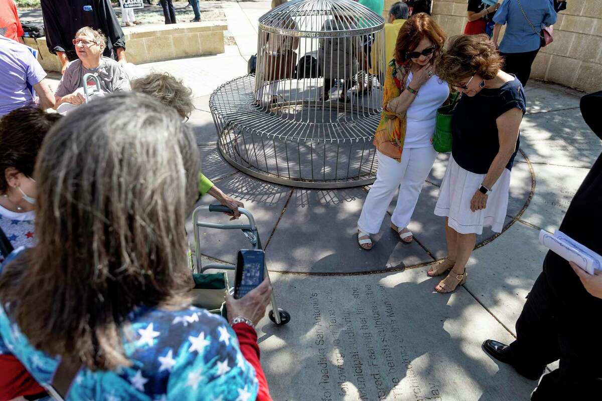 Carmen Tafolla, the noted Chicana poet, and Sharyll Teneyuca read a sidewalk etching at San Antonio’s Labor Plaza that honors Teneyuca’s aunt, Emma Tenayuca, leader of the 1938 pecan shellers’ strike.