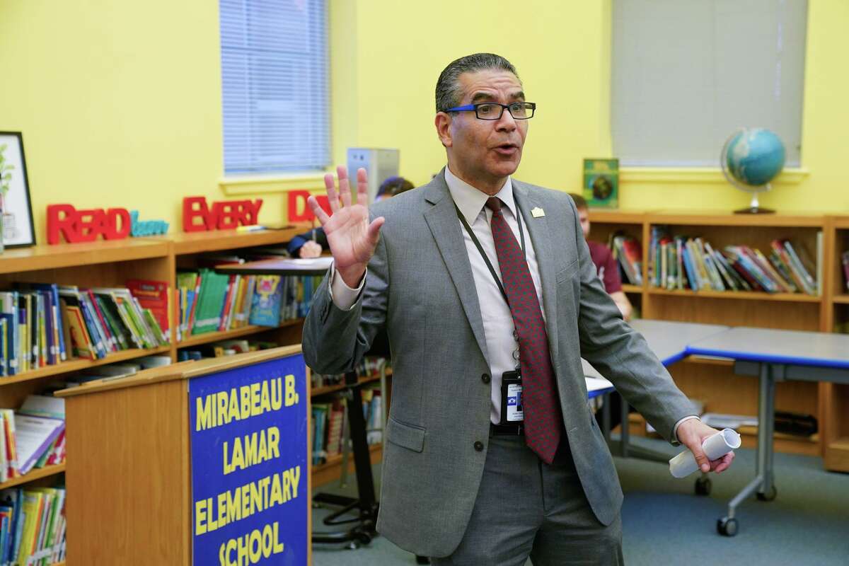 SAISD Superintendent Jaime Aquino addresses a community question and answer meeting Tuesday evening at Lamar Elementary School to discuss how the district rents to outside organizations. Opposition from the school community led the district to renegotiate its agreement to let a church use the school for Sunday services.