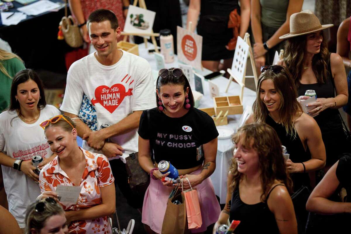 People react to Tori Larned, Beto O'Rourke's press secretary, as she talks about reproductive rights and the importance of voting during the Fun(damental Rights) on Weekdays Happy Hour at Blue Norther Hard Seltzer in Austin, Texas, Tuesday, July 12, 2022.