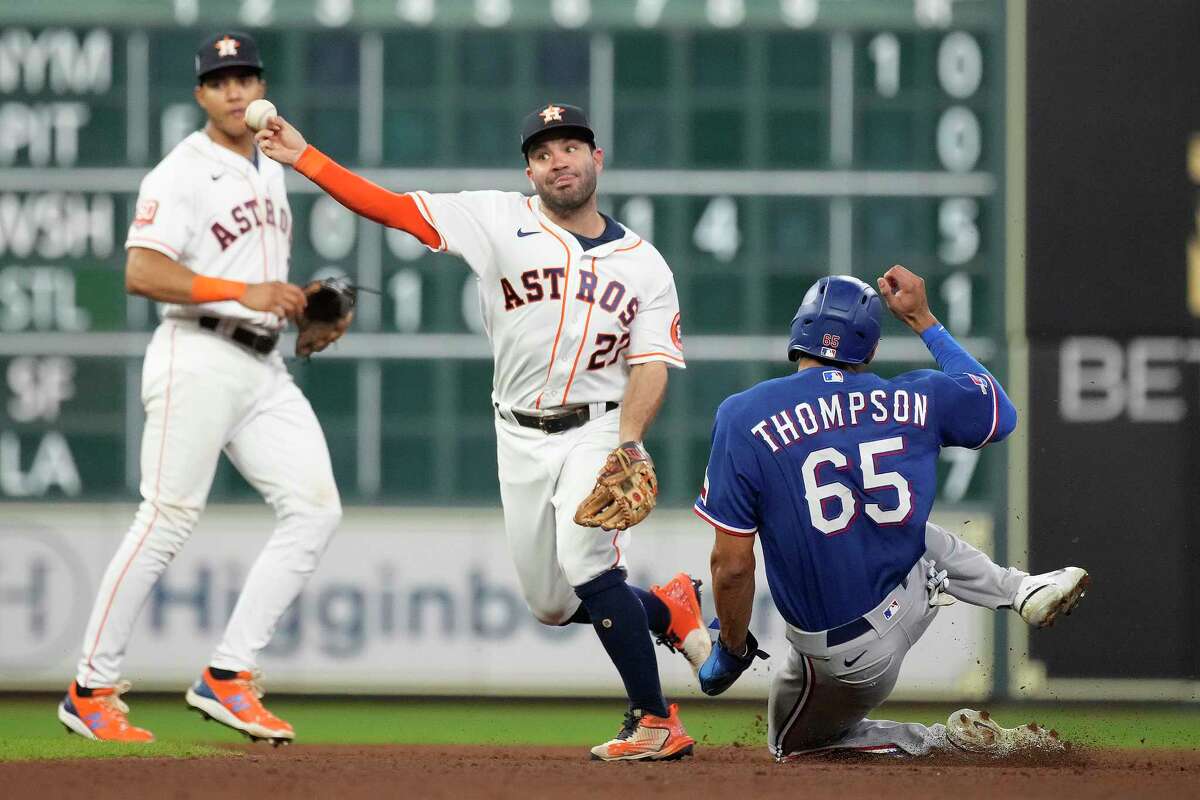 Houston Astros second baseman Jose Altuve (27) turns the double play on a Texas Rangers ground ball from Marcus Semien after getting the force on Bubba Thompson at second base during the seventh inning at Minute Maid Park on Wednesday, Sept. 7, 2022.