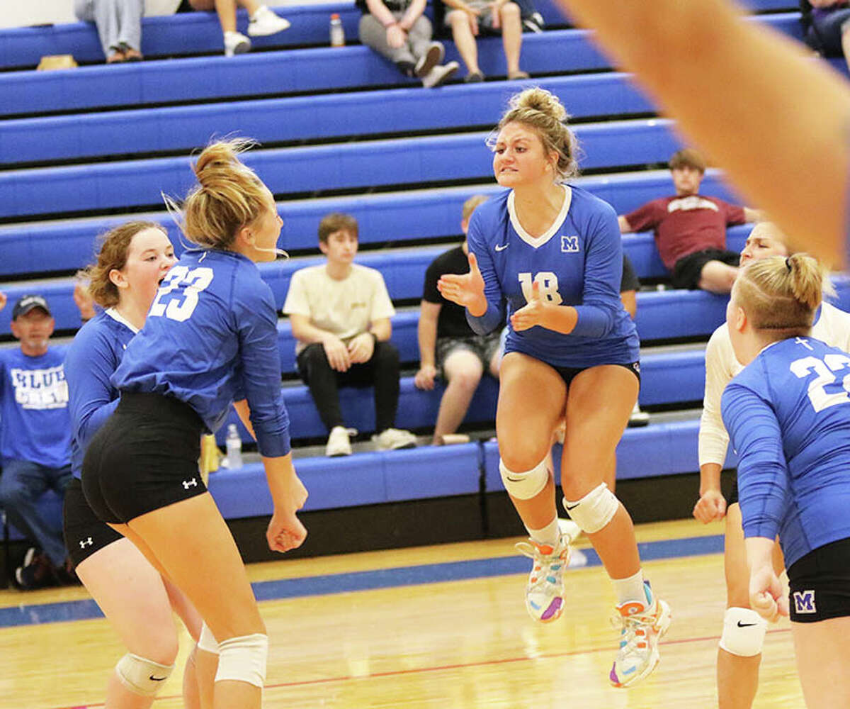 Marquette Catholic's Arista Bunn (18) celebrates a three-set win over Jersey with teammates last month at the Roxana Tourney. The teams met again Wednesday, with the Explorers beating the Panthers in two sets at Jerseyville.