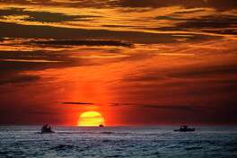 Lobster fishermen are already at work as the sun rises over the Atlantic Ocean, Thursday, Sept. 8, 2022, off of Kennebunkport, Maine. (AP Phot6o/Robert F. Bukaty)