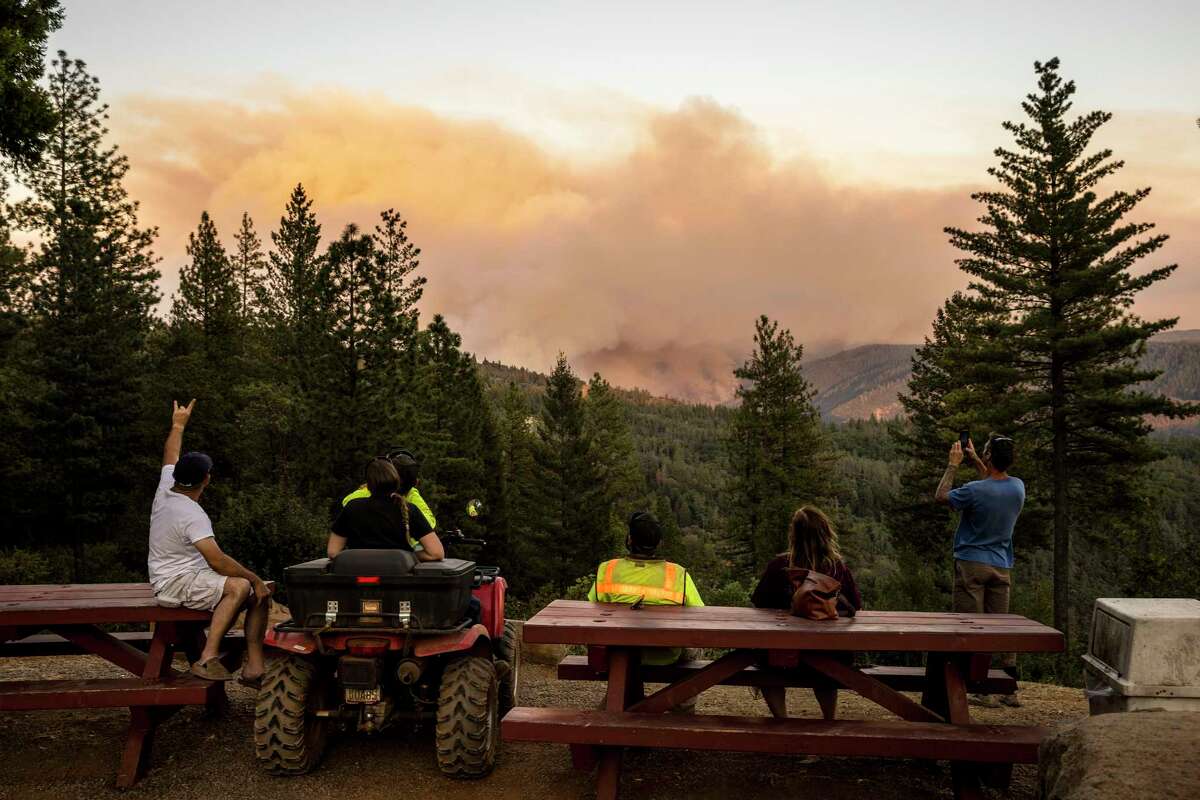 People watch from a distance as the Mosquito Fire burns near Michigan Bluff in unincorporated Placer County, Calif. Wednesday, Sept. 7, 2022. 