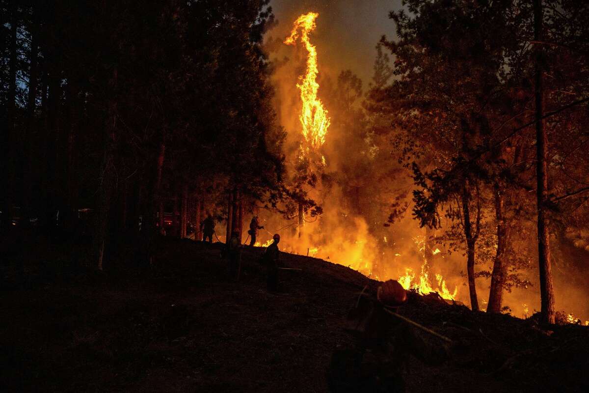 Firefighters battle the Mosquito Fire near Michigan Bluff in unincorporated Placer County, Calif. Wednesday, Sept. 7, 2022. (Stephen Lam/San Francisco Chronicle via AP)