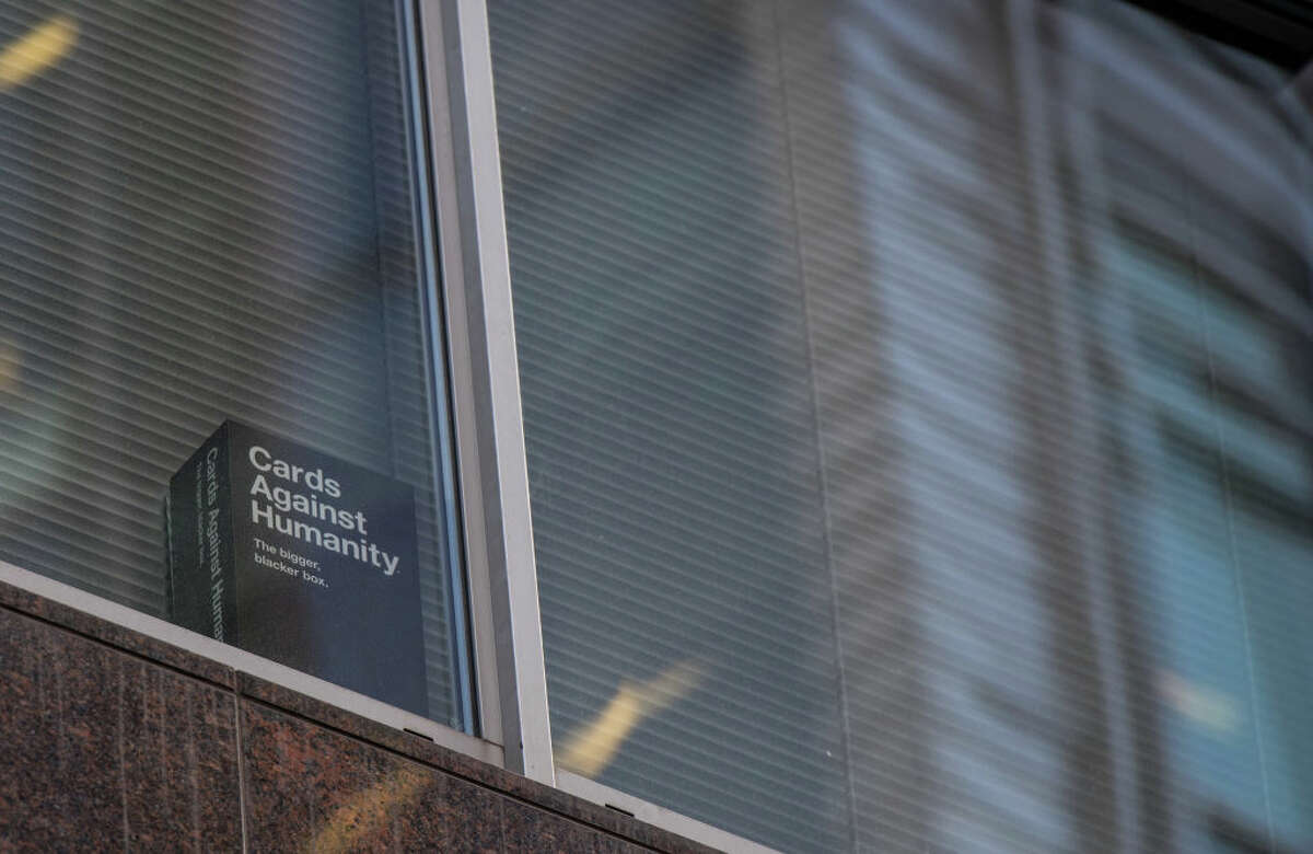 A copy of the game 'Cards Against Humanity' is seen in a London window on March 21, 2018. The company has announced a new initiative to give money to abortion funds.