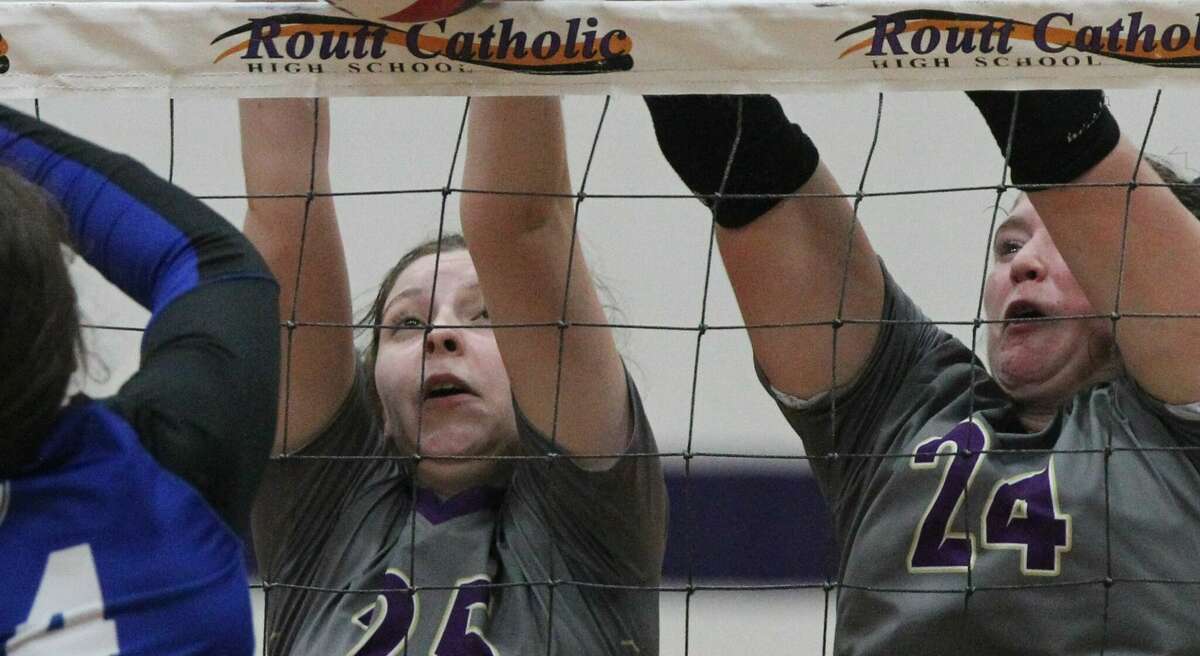 Routt's Julia Beeley (left) and Hannah Parlier team up for a block during a volleyball match against Springfield Lutheran at the Routt Dome Tuesday night. Results in Scoreboard.