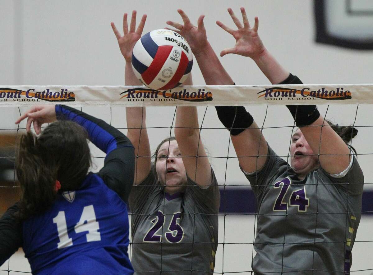 Routt's Julia Beeley (left) and Hannah Parlier team up for a block during a volleyball match against Springfield Lutheran at the Routt Dome Tuesday night. Results in Scoreboard.