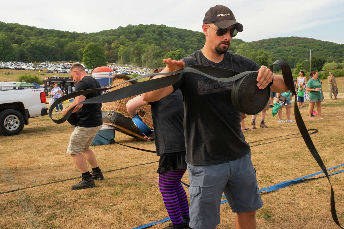 A crew member takes the lead during the Crew Olympics reeling in the dropline. During the descent, once the wind has died down, the pilot throws the dropline to a crew member to help pull in the basket.