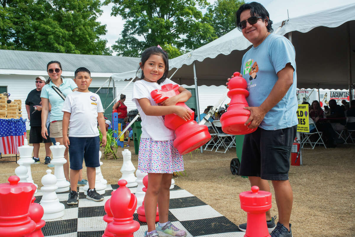 A family plays giant chess at the Hudson Valley Hot Air Balloon Festival.