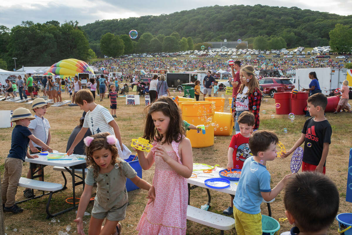 Children blow bubbles at the Hudson Valley Hot Air Balloon Festival at Tymor Park on Saturday, September 3, 2022.