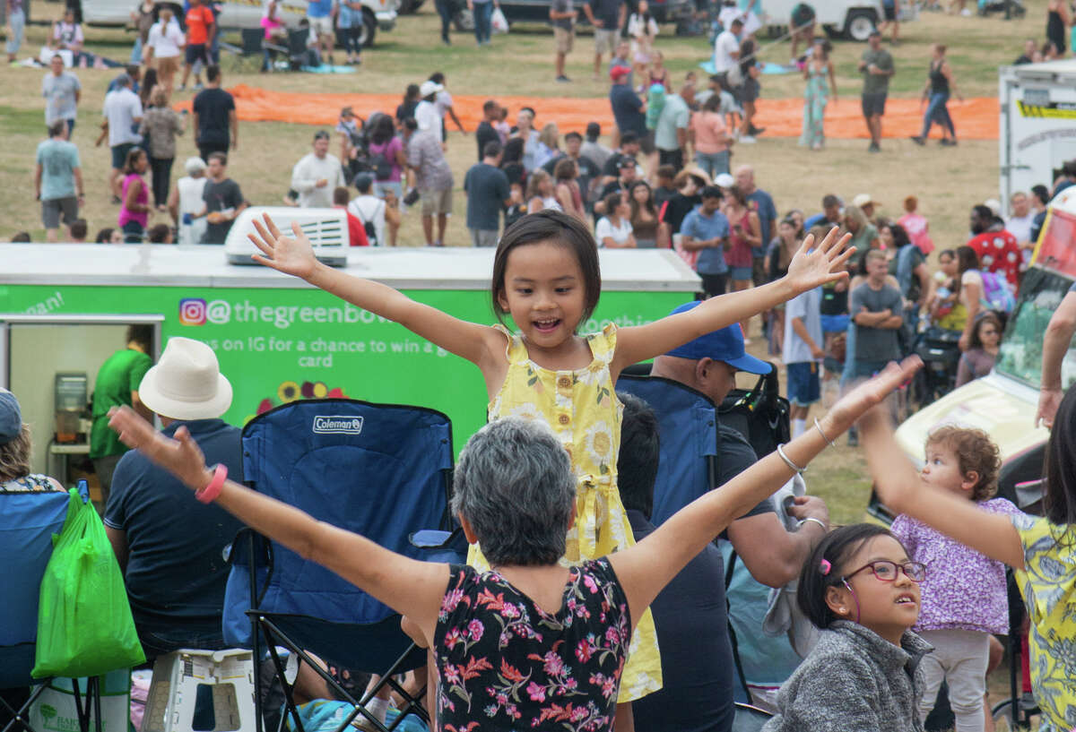 A mother and daughter dance to the YMCA while IHeart Radio DJs spin for revelers at the Hudson Valley Hot Air Balloon Festival.