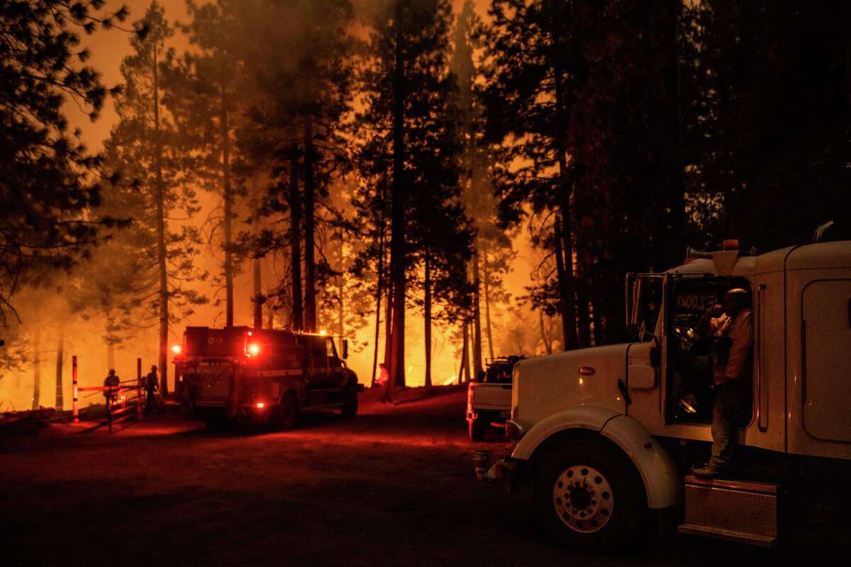 A water tender driver watches as firefighters battle the Mosquito Fire near Michigan Bluff in unincorporated Placer County, Calif. Wednesday, Sept. 7, 2022.