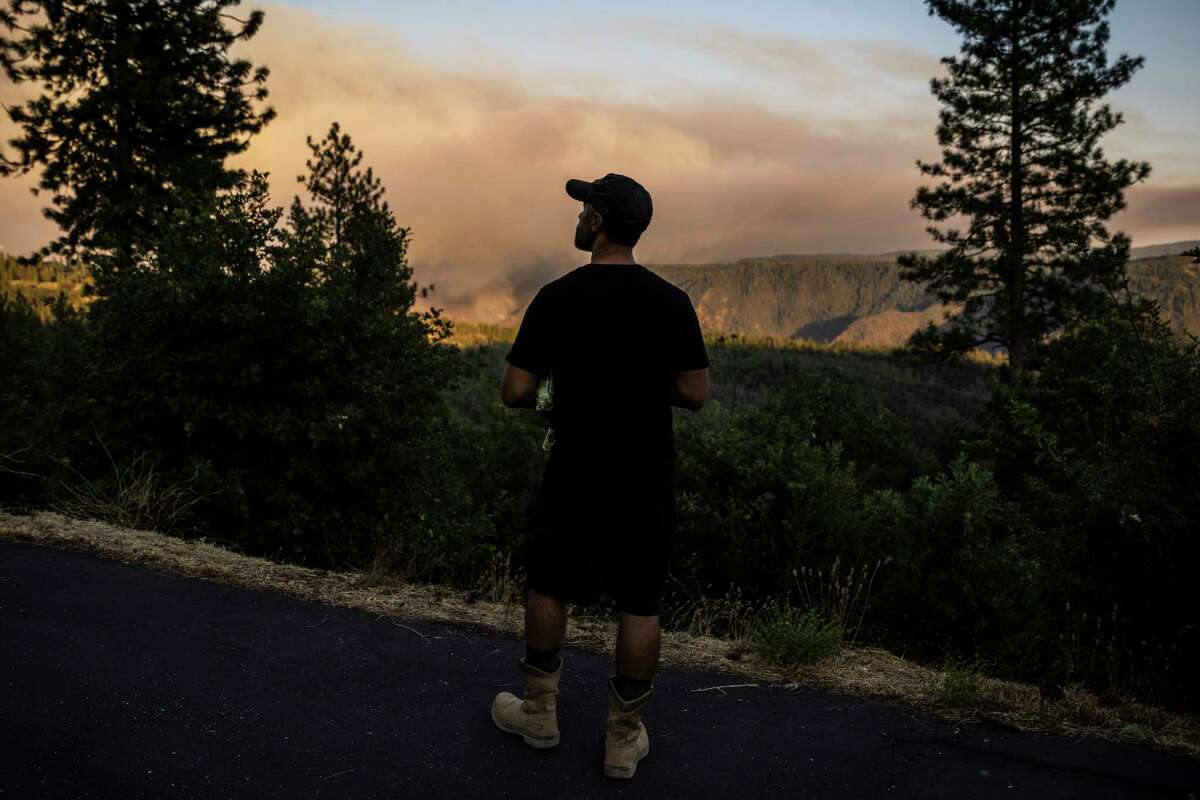 Community of the Great Commission resident David Taylor, who moved into the community this past December, watches as the Mosquito Fire burns from a distance in Foresthill in unincorporated Placer County, Calif. Wednesday, Sept. 7, 2022.