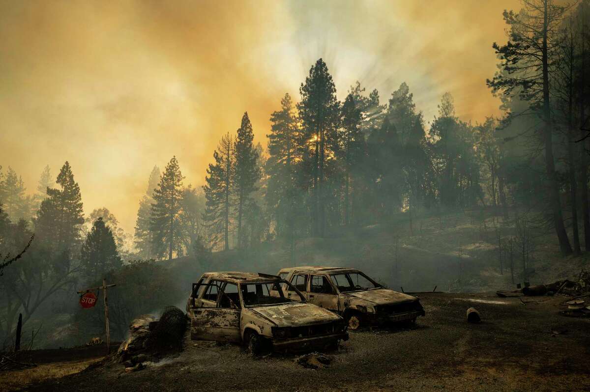Scorched vehicles rest in a clearing as the Mosquito Fire burns along Michigan Bluff Rd. in unincorporated Placer County, Calif., on Wednesday, Sept. 7, 2022. (AP Photo/Noah Berger)