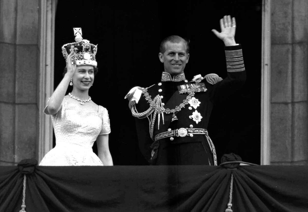Queen Elizabeth II and Prince Philip, duke of Edinburgh, wave to supporters from the balcony at Buckingham Palace following her coronation in 1953.