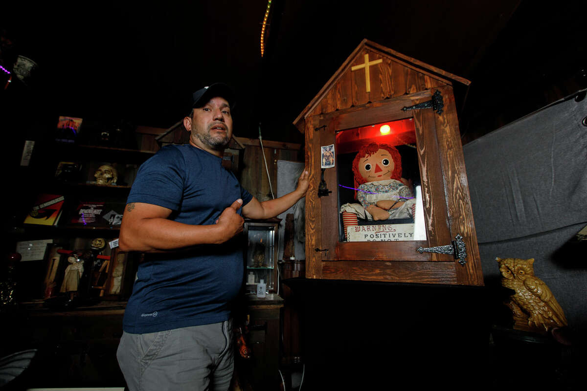 Dan Rivera, Senior Lead Investigator of the New England Society for Paranormal Research stands in front of the case that houses the Annabelle doll in Monroe, Conn. on Sept. 6, 2022.