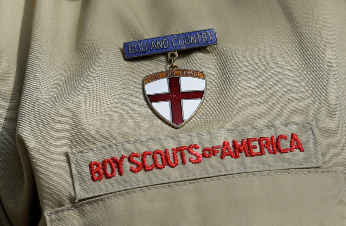 FILE - A close up of a Boy Scout uniform is photographed on Feb. 4, 2013, in Irving, Texas. A Delaware bankruptcy judge has approved a $2.46 billion reorganization plan Thursday, Sept. 8, 2022, proposed by the Boy Scouts of America that would allow it to continue operating while compensating tens of thousands of men who say were sexually abused as children while involved in Scouting.