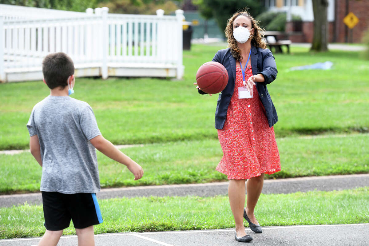 Dr. Laine Taylor plays basketball with a child client at The Village for Families & Children, in Hartford, Conn. Sept. 7, 2022.