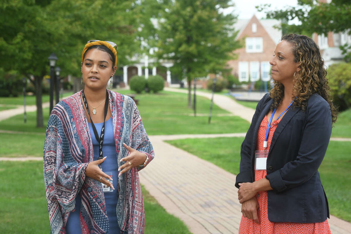 Chelsea Natal, left, stands with Dr. Laine Taylor as they speak during a tour and interview at The Village for Families & Children, in Hartford, Conn. Sept. 7, 2022.