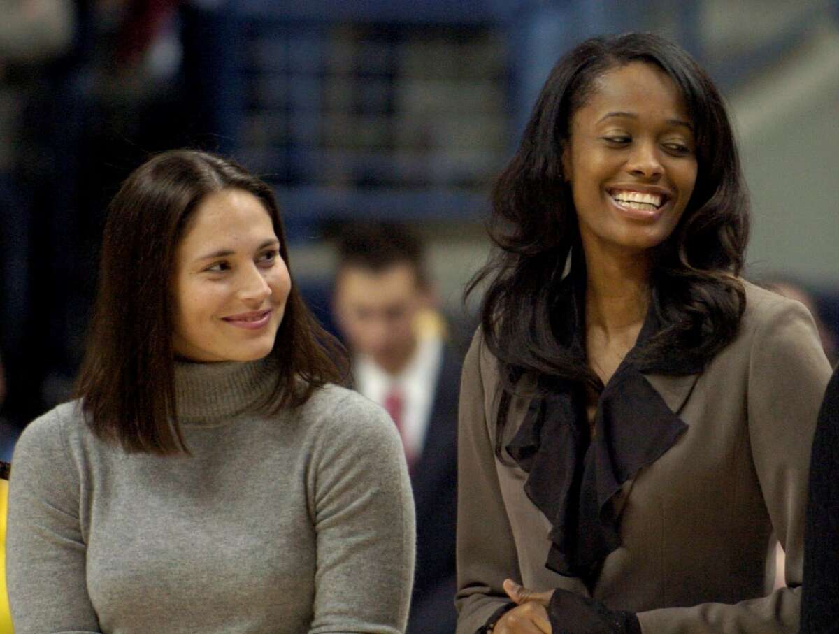 Former University of Connecticut women's basketball players Sue Bird, left, Swin Cash, center, and Diana Taurasi share a light moment during the Huskies of Honor induction ceremony at Gampel Pavillion in Storrs, Conn., Thursday, Dec. 21, 2006. Ten First Team All-Americans and Hall of Fame head coach Geno Auriemma were honored as the inaugural class. (AP Photo/Jessica Hill)