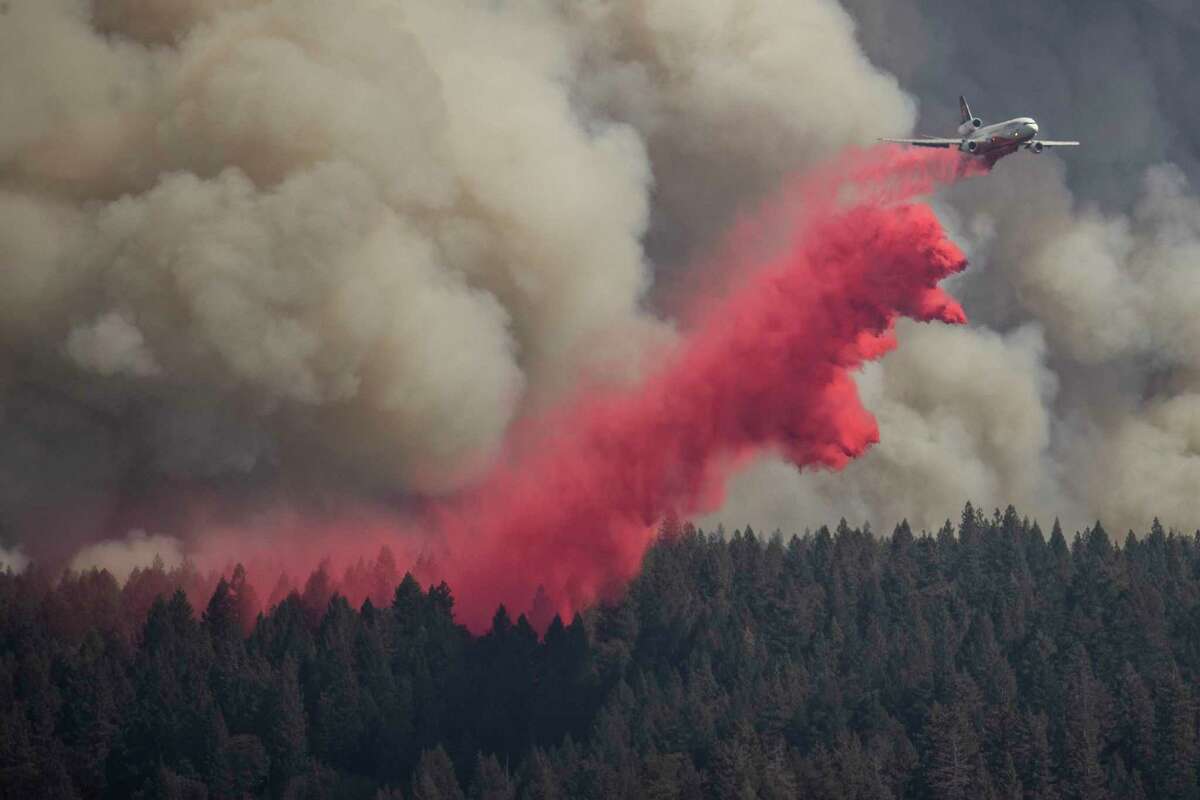 A firefighting air tanker releases fire retardant while battling the Mosquito Fire in unincorporated Placer County, Calif. Thursday, Sept. 8, 2022.
