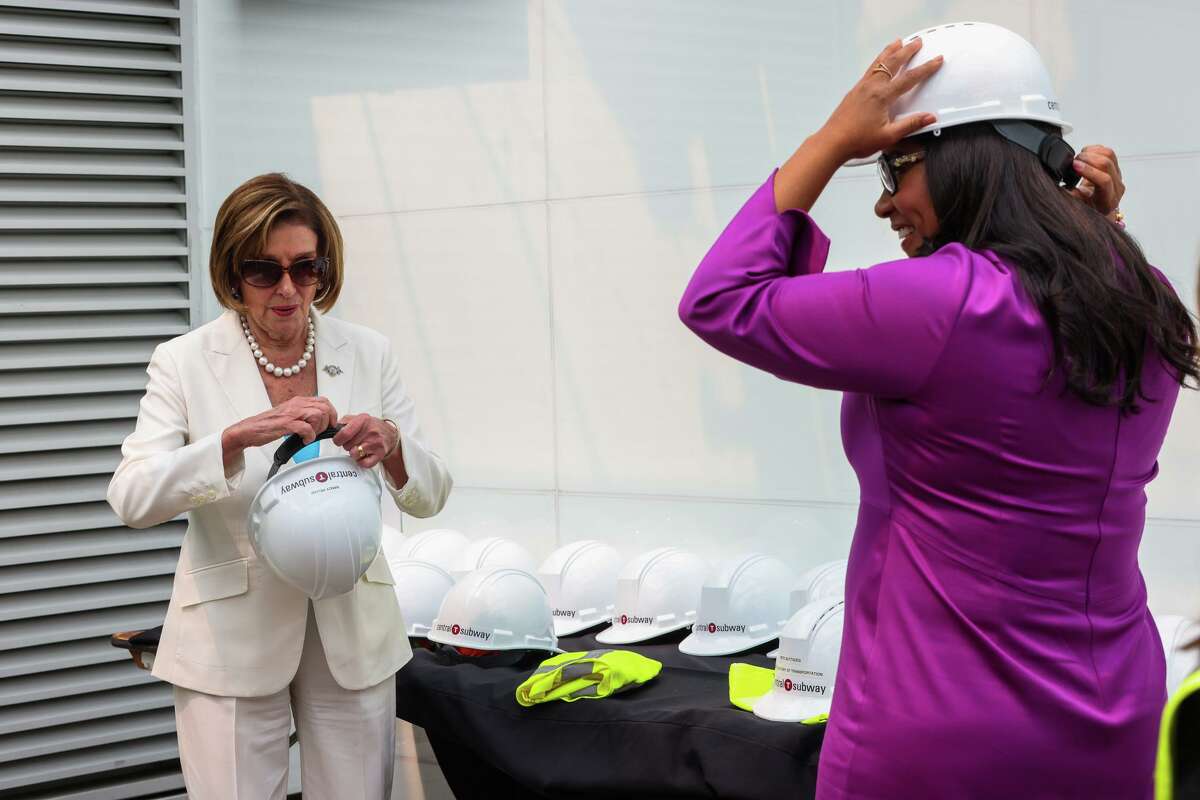 House Speaker Nancy Pelosi (left) and San Francisco Mayor London Breed prepare to wear hard hats as they arrive for a tour of San Francisco’s long-delayed Central Subway project.