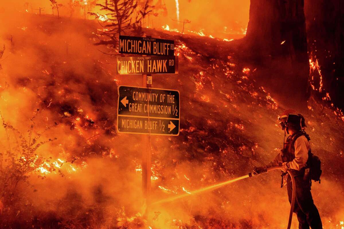 A firefighter battles the Mosquito Fire burning near the Michigan Bluff community in unincorporated Placer County, Calif., on Wednesday, Sept. 7, 2022.