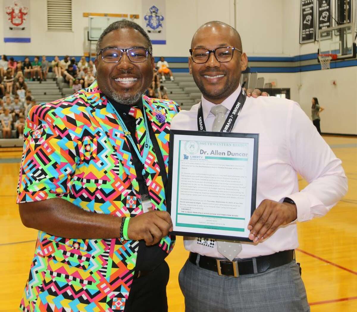 Dr. Tron Young, principal at Joseph Arthur Middle School in O’Fallon, Illinois, presents Dr. Allen Duncan, principal at Liberty Middle School in Edwardsville, with his award for being named the Illinois Principals Association Southwestern Region Principal of the Year.