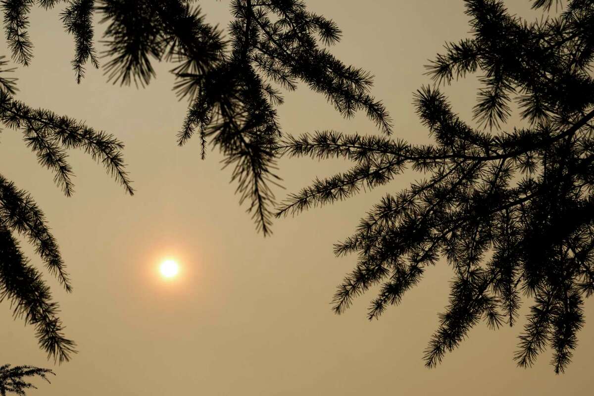 The sun peeks through heavy smoke over an evacuation center at Bell Road Baptist Church in Auburn, Calif. Friday, Sept. 9, 2022 after evacuating from the Mosquito Fire in unincorporated Placer County south of Foresthill.