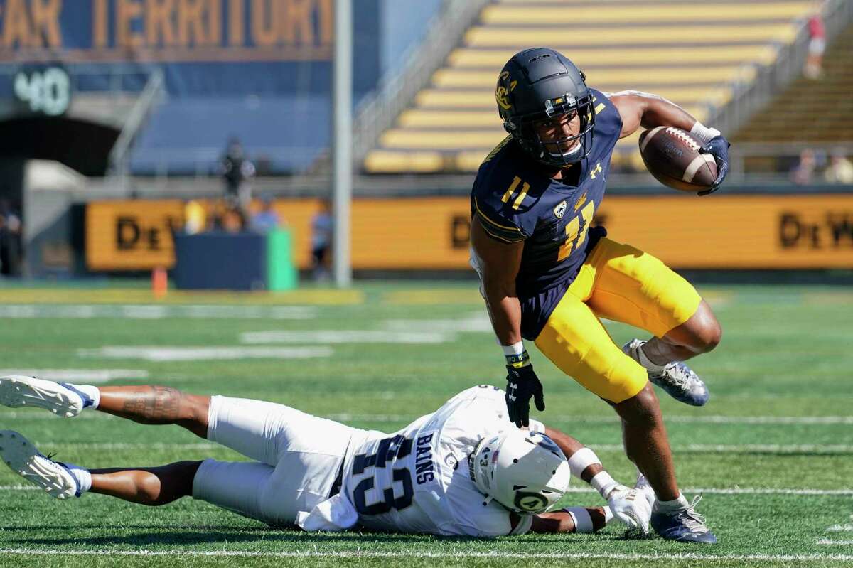 California wide receiver Mavin Anderson (11) gets past a tackle attempt by UC Davis defensive back Kavir Bains (43) on his way to a 14-yard touchdown reception during the second half of an NCAA college football game in Berkeley, Calif., Saturday, Sept. 3, 2022. (AP Photo/Godofredo A. Vásquez)