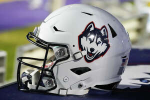 UConn football player charged, not taking part in team activities