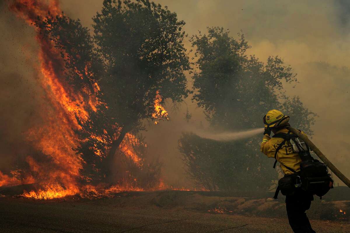 A firefighter attacks on brush fire on third day of Fairview Fire along in Bautista Canyon Road on Wednesday, Sept. 7, 2022, in Hemet, California. Meteorologist Garry Lesser said there could be a haze seen in Connecticut skies this weekend due to the wildfires.