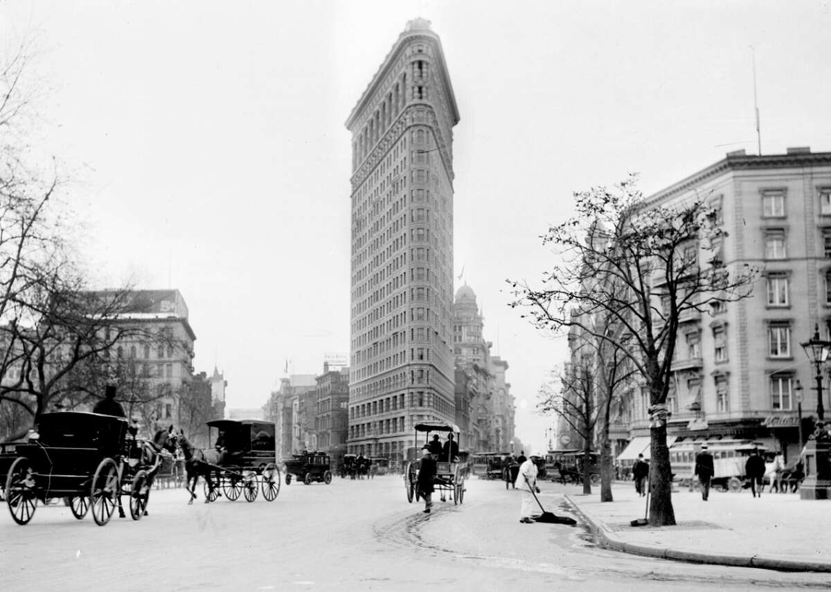 Skyscrapers When George A. Fuller Construction Co. built New York City's iconic Flatiron Building in 1902, it was one of the city's tallest buildings. The 285-foot skyscraper was at the time more than 100 feet taller than the Home Insurance Building, which popped up in Chicago in 1885 at 138 feet and grew to 180 feet in 1890 after some additions. Yet today, it pales in comparison to the hundreds of buildings within the city's limits—including 17 that are more than 1,000 feet tall. Chicago's Home Insurance Building differed due to its iron skeleton that was a departure from its wood or pure masonry predecessors. Designer William Le Baron Jenney, an engineer and former classmate of the designer of the Eiffel Tower, drummed up the idea of an iron skeleton building after seeing his wife place a heavy book on a small birdcage. Several technological advancements bolstered the growth of the skyscraper. Frames could be created using Bessemer steel, which was more flexible than cast iron. And sprinkler heads allowed buildings to expand beyond limits previously imposed to control fire risk. The patenting of actuating current, or AC, electricity also helped elevators to more easily reach higher floors.