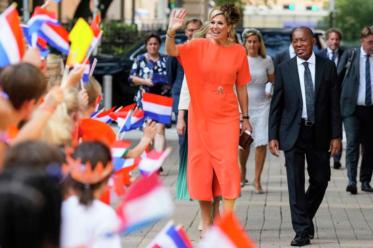 Queen Maxima, of the Netherlands, waves to a gathering of school children as she walks with Houston Mayor Sylvester Turner as she arrives at City Hall on Friday, Sept. 9, 2022, in Houston. (Brett Coomer/Houston Chronicle via AP)