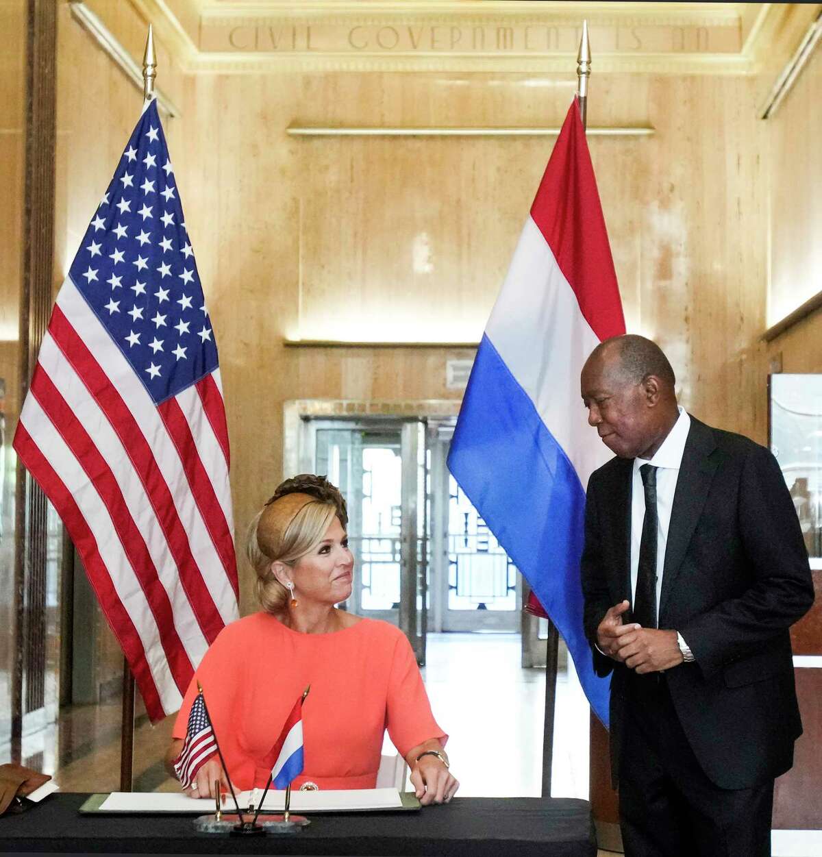 Queen Maxima, of the Netherlands, signs a book with Houston Mayor Sylvester at City Hall on Friday, Sept. 9, 2022 in Houston. (Brett Coomer/Houston Chronicle via AP)