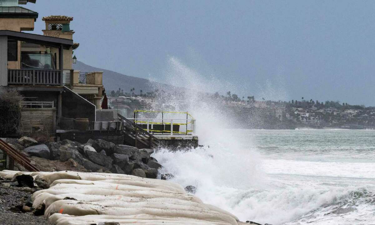 Waves crash into boulders in front of homes at Capistrano Beach in Dana Point (Orange County) on Friday. The remains of Hurricane Kay combined with the morning high tide brought the danger of further erosion to the area.