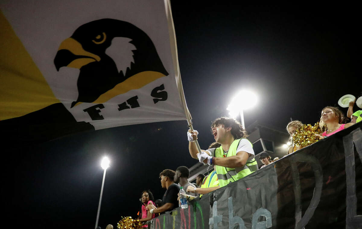 Foster student Brady Werner waves a flag during the second half of a game between Foster and Terry in Rosenberg on Sept. 9, 2022. 
