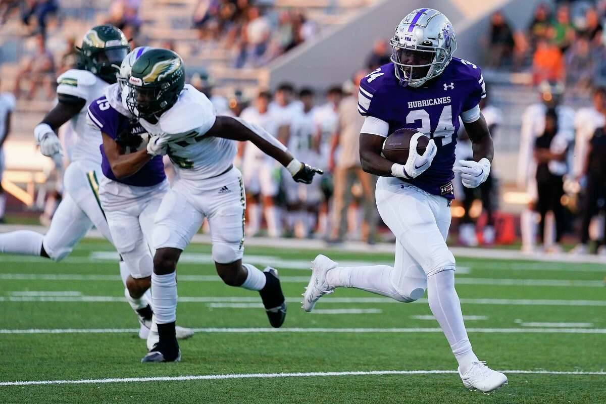 Klein Cain running back Adeyemi Adeleke, right, runs for a touchdown during the first half of a high school football game against Cy Falls, Friday, Sept. 9, 2022, in Klein.