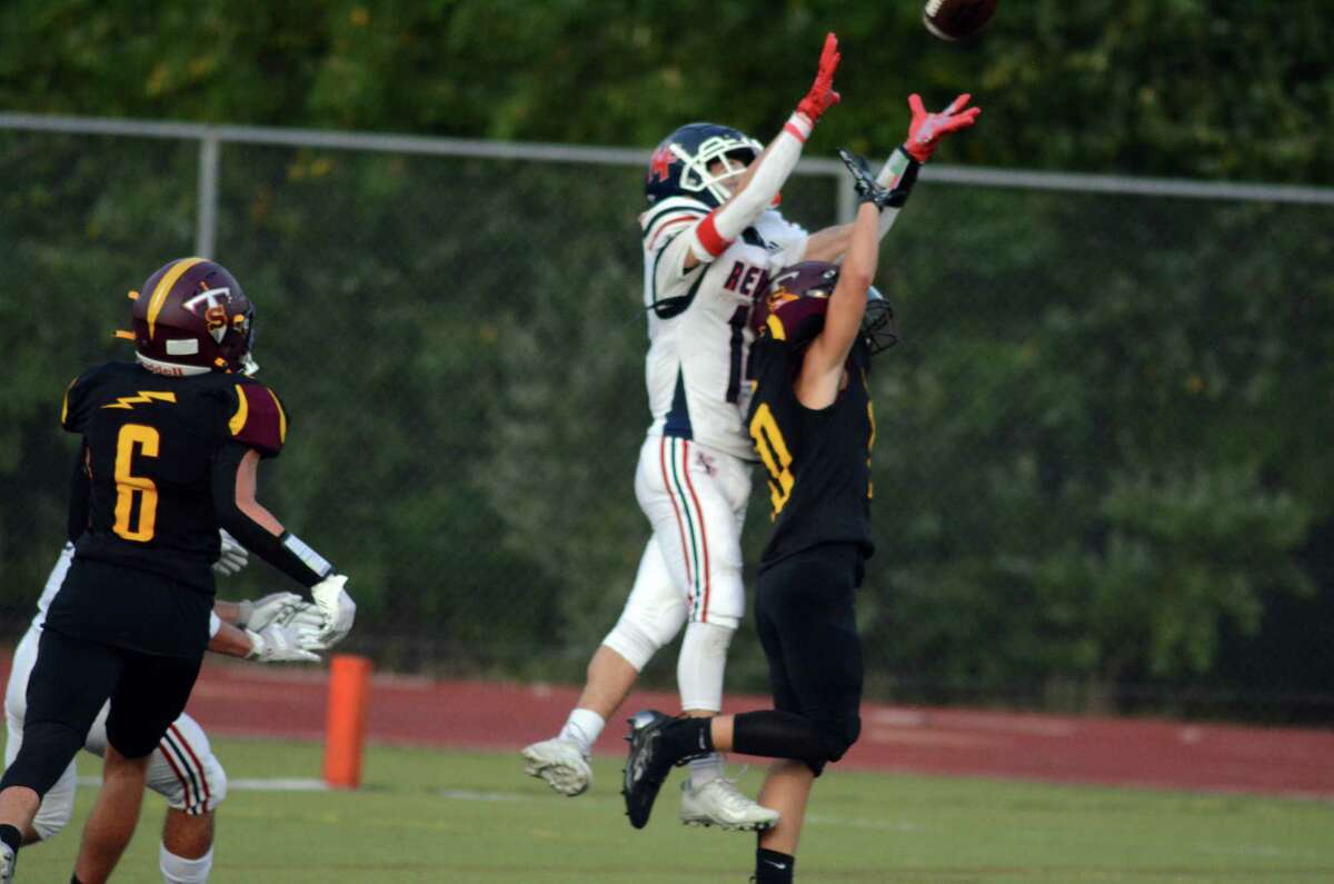 Neew Fairfield's Chris Mango goes up for the ball while outleaping a Sheehan defender for what would be a 27-yard touchdown catch during the Rebels' 40-21 win over Sheehan on Friday, September 9, 2022 in Wallingford, Conn.