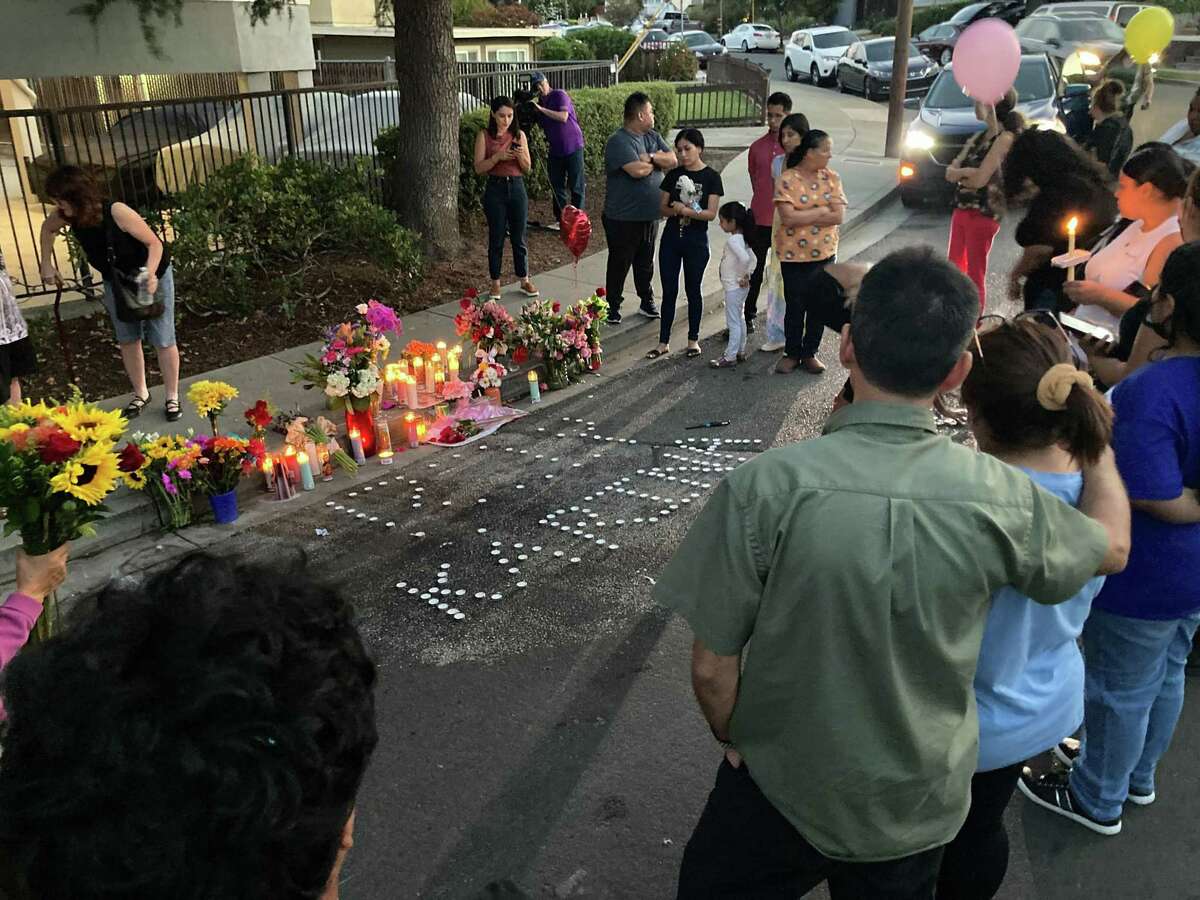 People gather for a vigil for Karina Castro at the site of her slaying in San Carlos on Friday, Sept. 9, 2022.