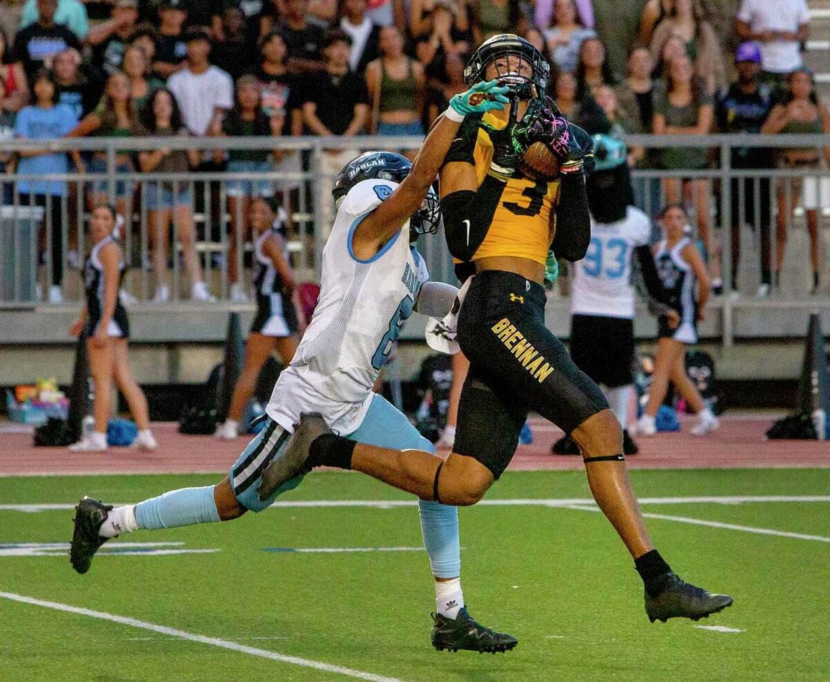 Brennan wide receiver Armando Acevedo, right, comes down with a pass Friday night, Aug. 9, 2022, at Gustafson Stadium while defended by Harlan’s Isaiah Brock during the first half of the Bears’ game against the Hawks.