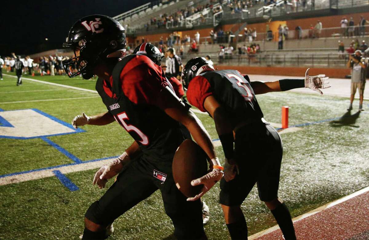 Churchill’s Diego Marsh celebrates with teammates after scoring a touchdown against Madison in the second overtime which helped the Chargers clinch the win on Friday, Sept. 9, 2022. Churchill defeated Madison, 25-23, in double overtime.