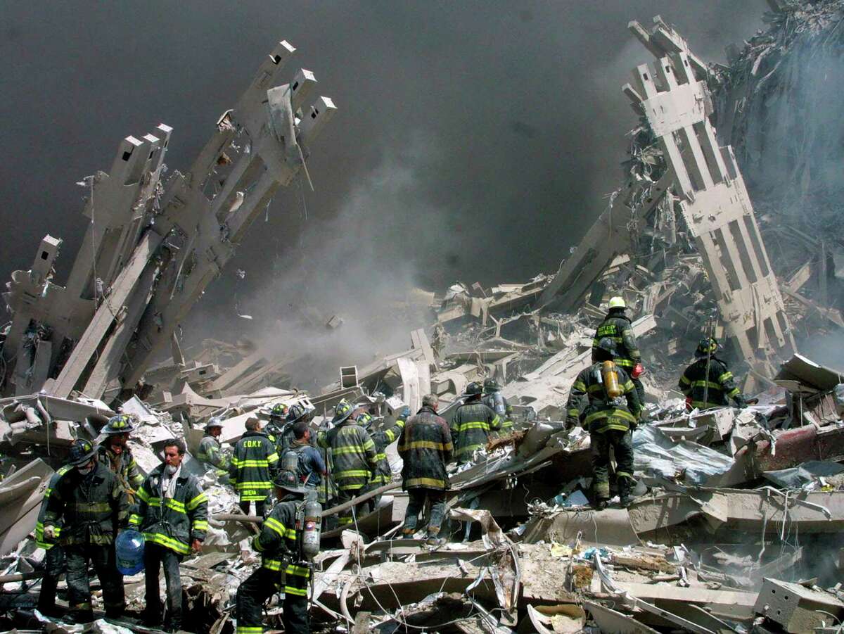Firefighters make their way through the rubble after two airliners crashed into the World Trade Center in New York bringing down the landmark buildings, Sept. 11, 2001.