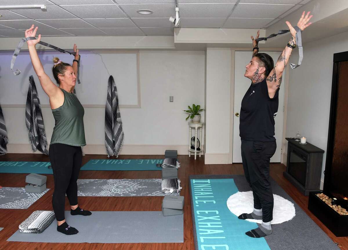 Jennifer Jardine, left, of Madison takes part in a stretch class with instructor Lisa Peterson at Trinity Stretch Studio in Branford.