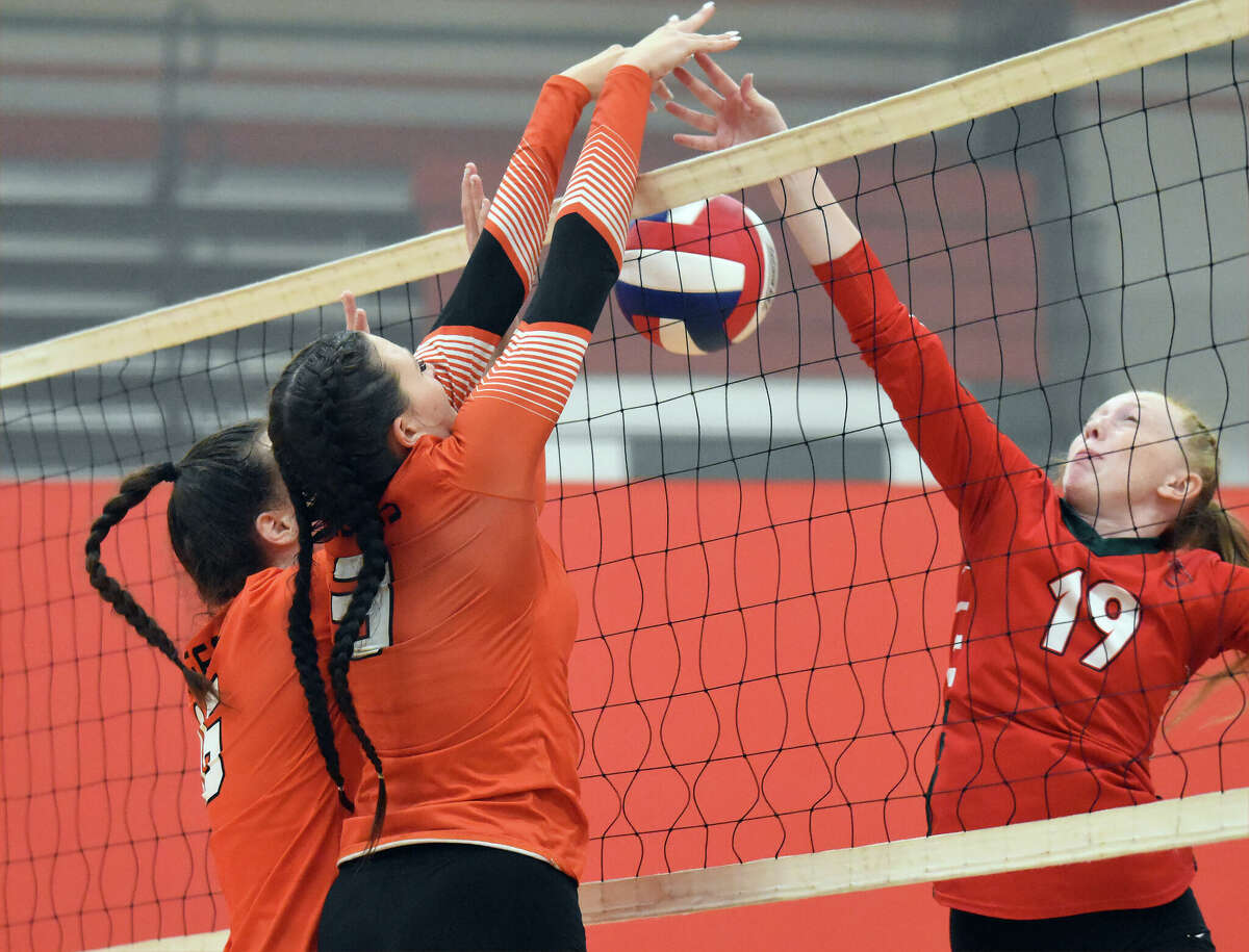 Edwardsville's Sydney Davis, left, and Ava Waltenberger get a block during Friday's action of the Crossroads Classic Volleyball Tournament in Effingham.