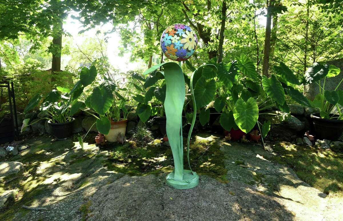 A floral themed sculpture at the home of Maryann Babcock in Branford. Her garden was inspired in part by some gardens featured in this exhibit.