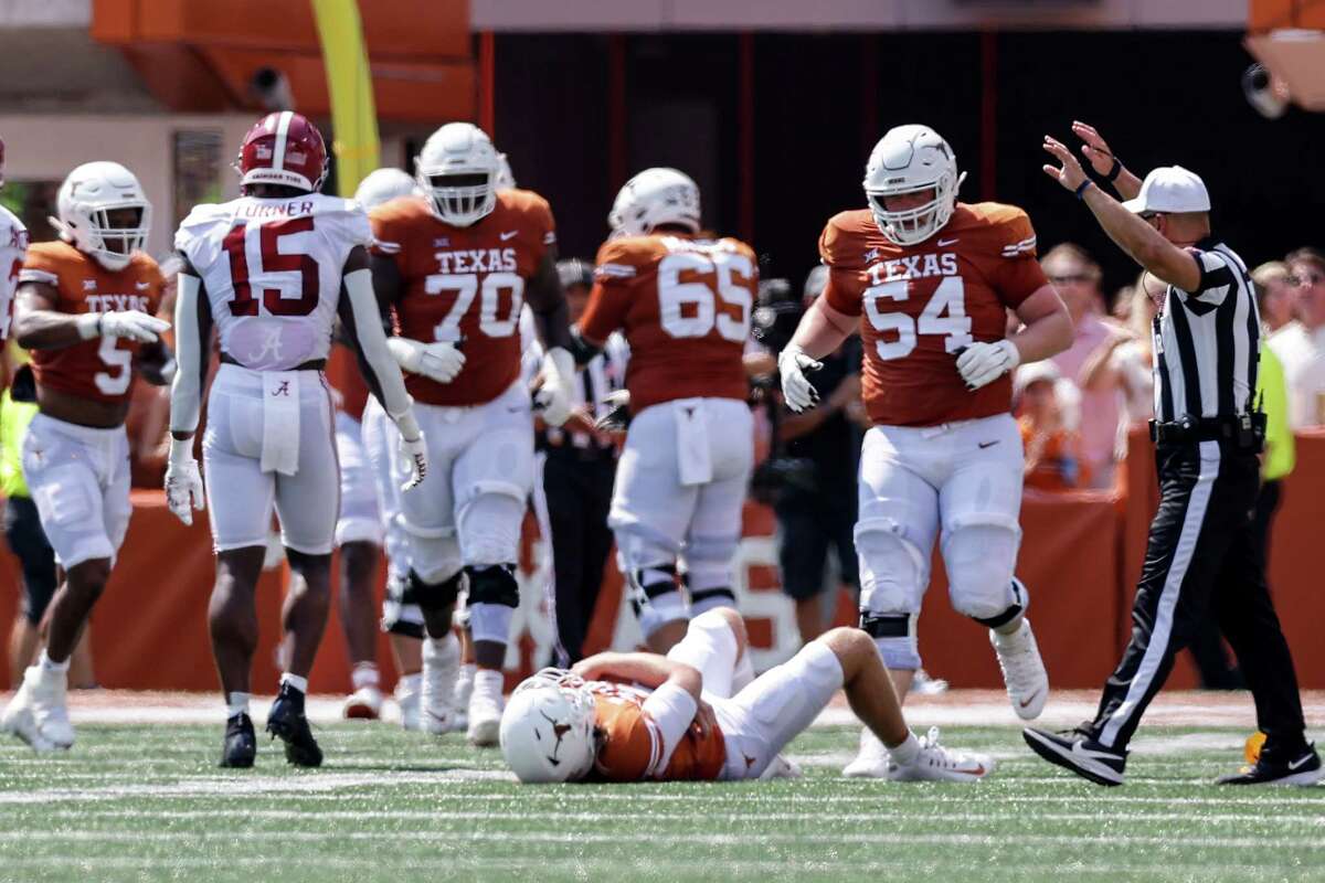 AUSTIN, TEXAS - SEPTEMBER 10: Quinn Ewers #3 of the Texas Longhorns lays injured on the turf after a late hit by Dallas Turner #15 of the Alabama Crimson Tide in the first half at Darrell K Royal-Texas Memorial Stadium on September 10, 2022 in Austin, Texas.