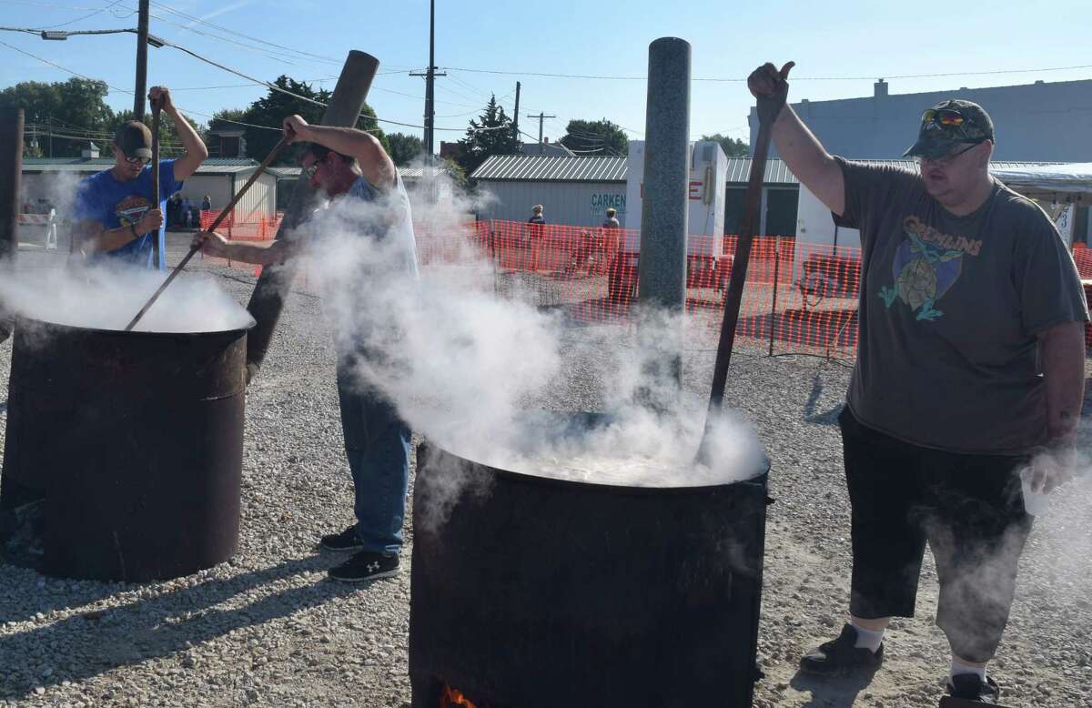 Greene County Days 2022 marked the return of burgoo to Roodhouse. Police Chief Kyle Robison (left), who serves as chief volunteer, works one of the paddles stirring the burgoo. "Roodhouse used to have a burgoo until about five years ago. Now we're trying to bring it back," Robison said.