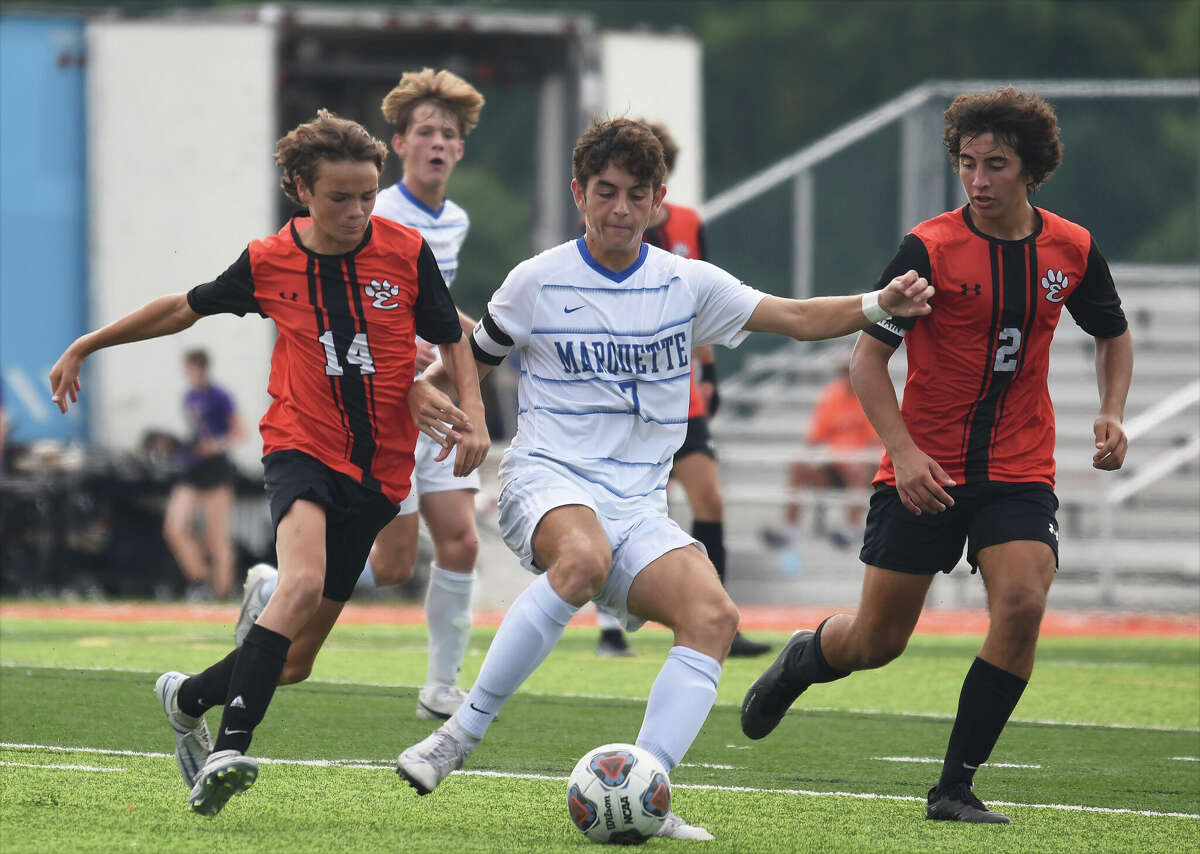 Edwardsville's Liam McLean, left, and Abe Gianaris chase after Marquette Catholic's Myles Paniague during Saturday's non-conference game inside the District 7 Sports Complex in Edwardsville.
